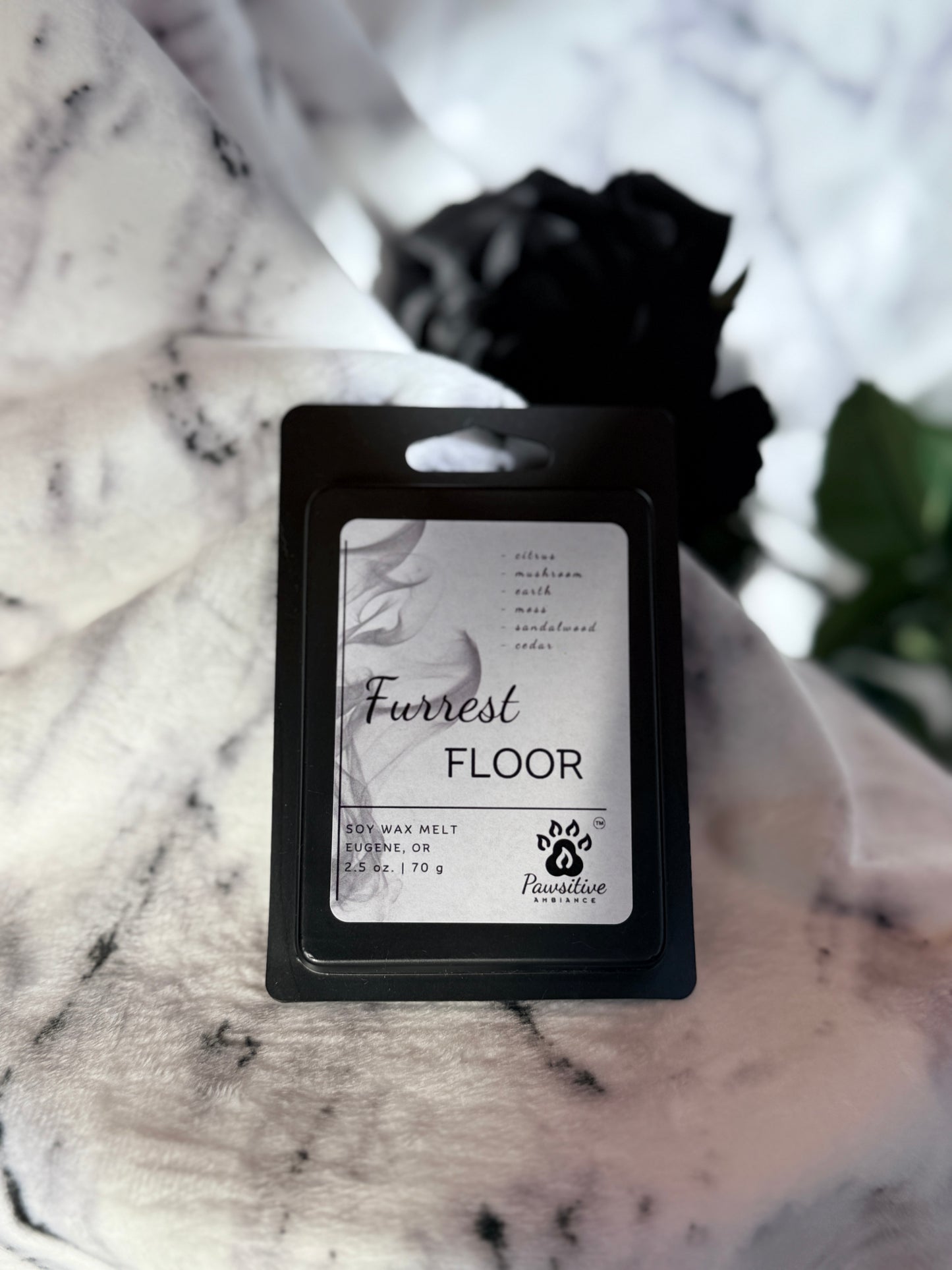 Soy wax melt labeled Furrest Floor featuring notes of citrus, mushroom, earth, moss, sandalwood and cedar. Made in Eugene, Oregon. 2.5 oz. Manufactured by Pawsitive Ambiance.