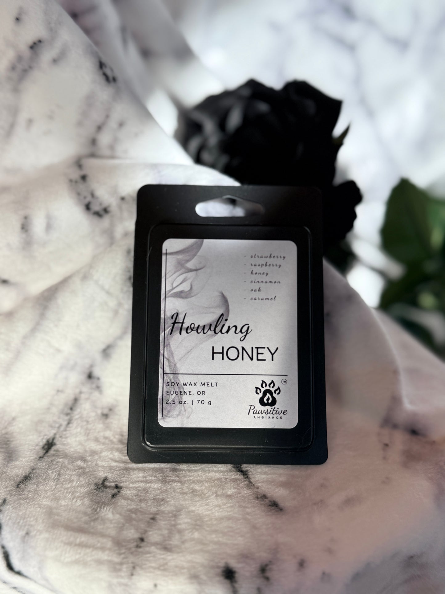 Soy wax melt labeled Howling Honey featuring notes of strawberry, raspberry, honey, cinnamon, oak and caramel. Made in Eugene, Oregon. 2.5 oz. Manufactured by Pawsitive Ambiance.