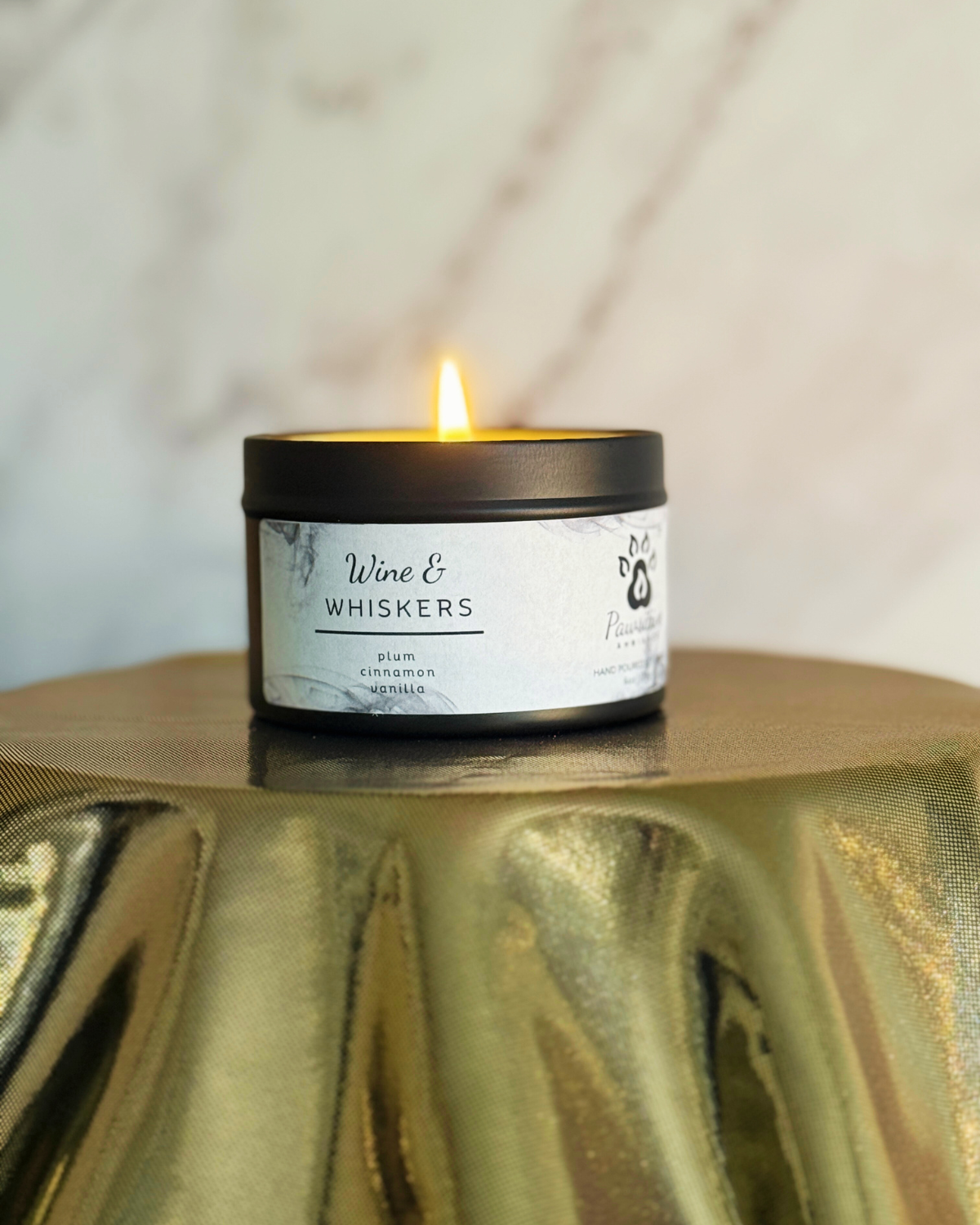 Hand-poured soy candle labeled Wine & Whiskers featuring notes of plum, cinnamon and vanilla. 6 oz. Manufactured by Pawsitive Ambiance.