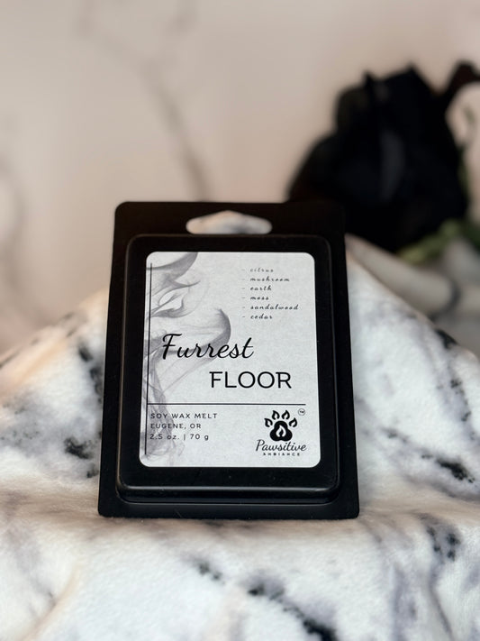 Hand-poured soy wax melt labeled Furrest Floor featuring notes of citrus, mushroom, earth, moss, sandalwood and cedar.  Made in Eugene, Oregon. 2.5 oz. Manufactured by Pawsitive Ambiance.