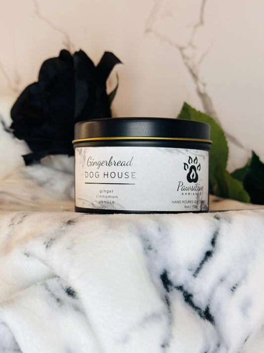 Hand-poured soy candle labeled Gingerbread Dog House featuring notes of ginger, cinnamon and vanilla.  6 oz. Manufactured by Pawsitive Ambiance.