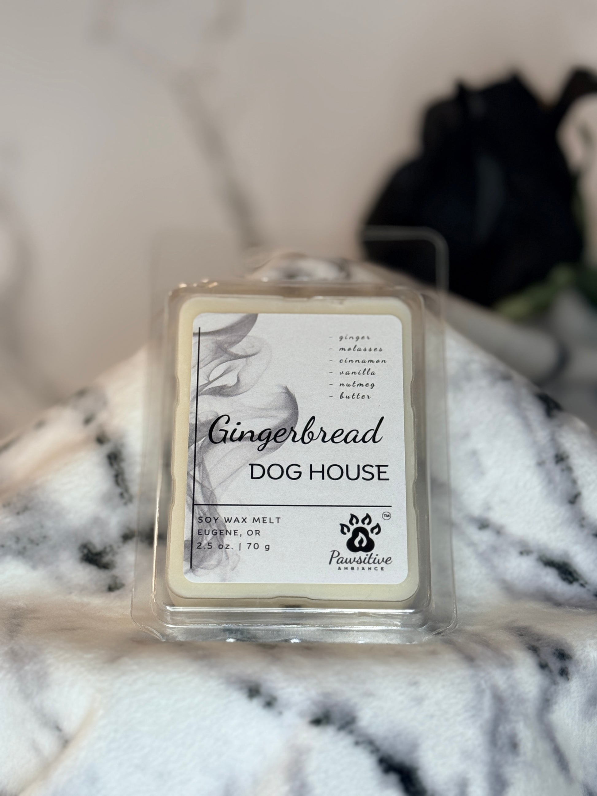Hand-poured wax melt labeled Gingerbread Dog House featuring notes of ginger, molasses, cinnamon, vanilla, nutmeg and butter.  2.5 oz. Manufactured by Pawsitive Ambiance.
