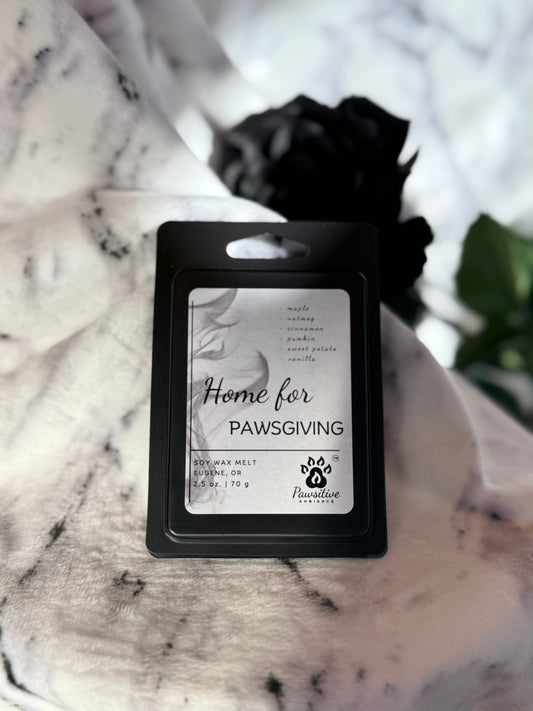 Soy wax melt labeled Home for Pawsgiving featuring notes of maple, nutmeg, cinnamon, pumpkin, sweet potato and vanilla.  Made in Eugene, Oregon. 2.5 oz. Manufactured by Pawsitive Ambiance.
