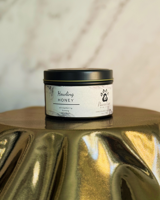 Hand-poured soy candle labeled Wine & Whiskers featuring notes of strawberry, honey and bourbon.  6 oz. Manufactured by Pawsitive Ambiance.
