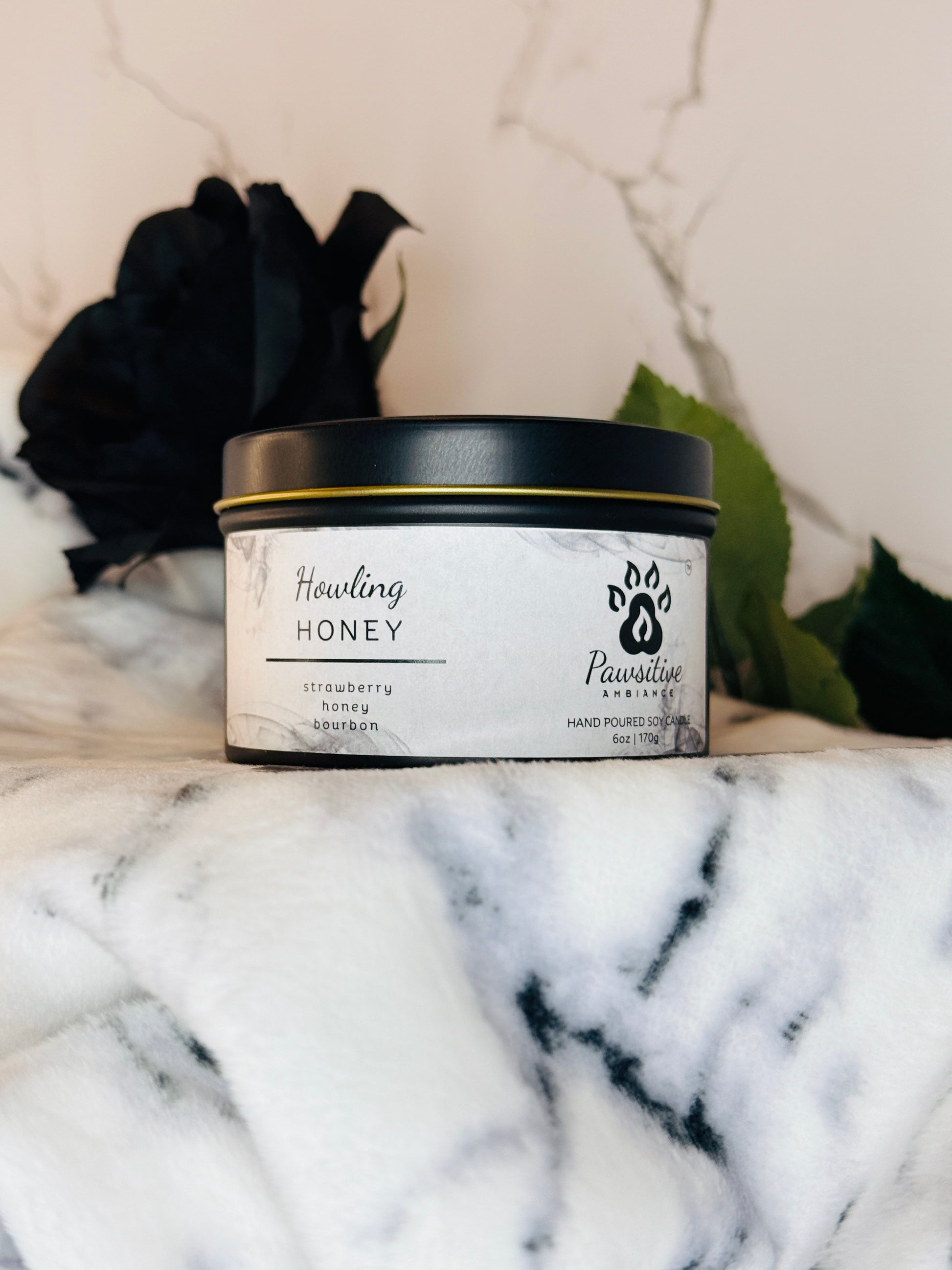 Hand-poured soy candle labeled Wine & Whiskers featuring notes of strawberry, honey and bourbon.  6 oz. Manufactured by Pawsitive Ambiance.