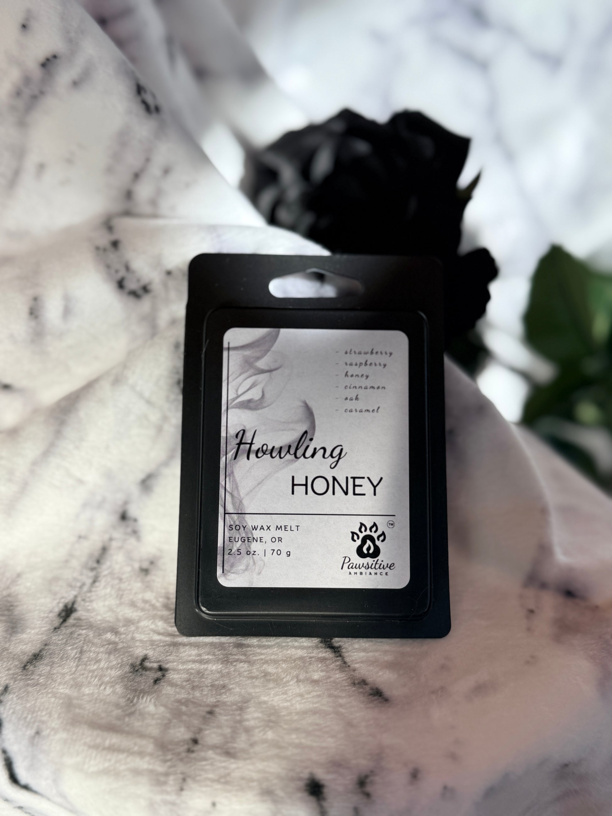 Soy wax melt labeled Howling Honey featuring notes of strawberry, raspberry, honey, cinnamon, oak and caramel.  Made in Eugene, Oregon. 2.5 oz. Manufactured by Pawsitive Ambiance.