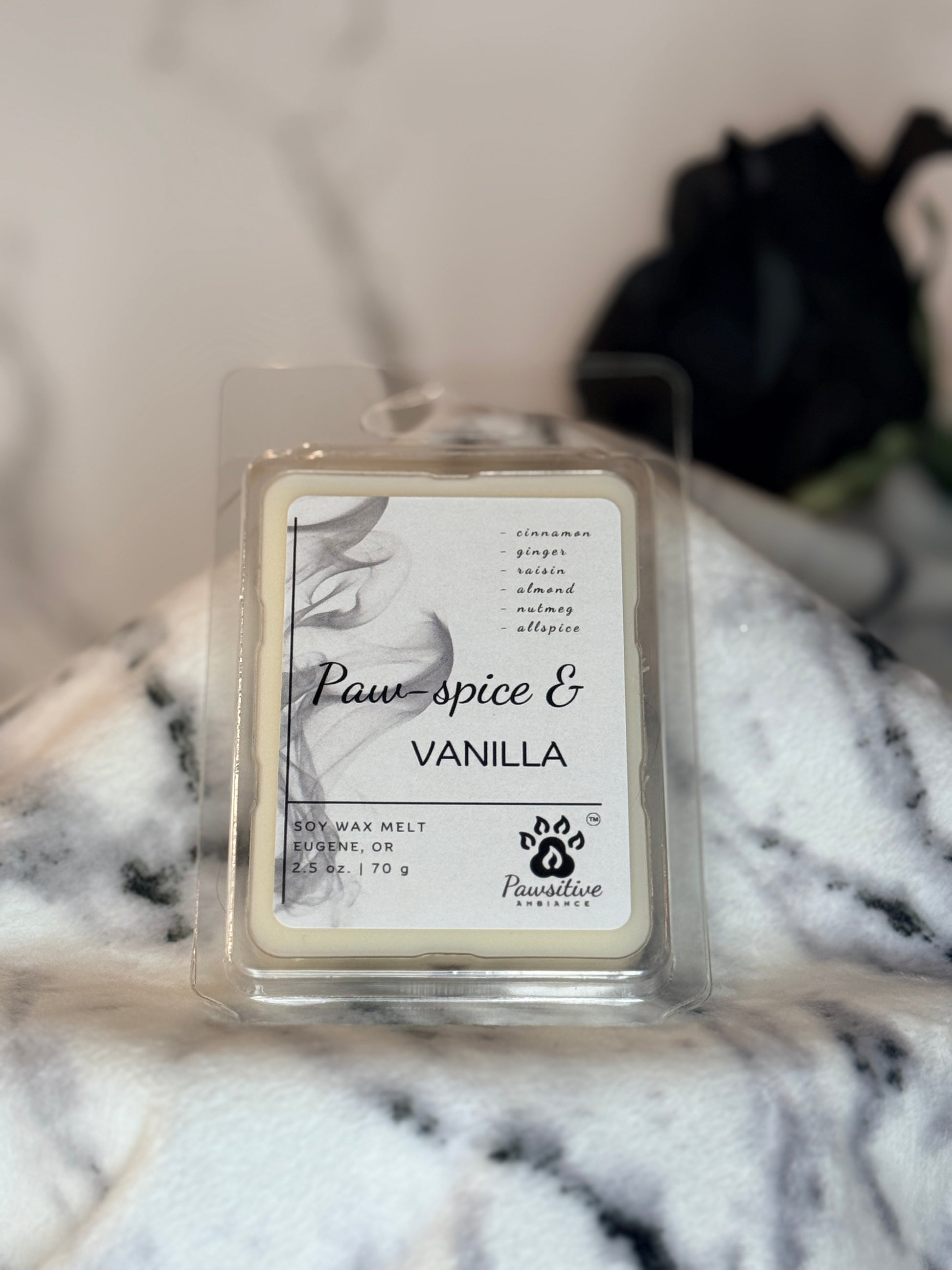 Hand-poured wax melt labeled Paw-Spice & Vanilla featuring notes of cinnamon, ginger, raisin, almond, nutmeg and allspice.  2.5 oz. Manufactured by Pawsitive Ambiance.
