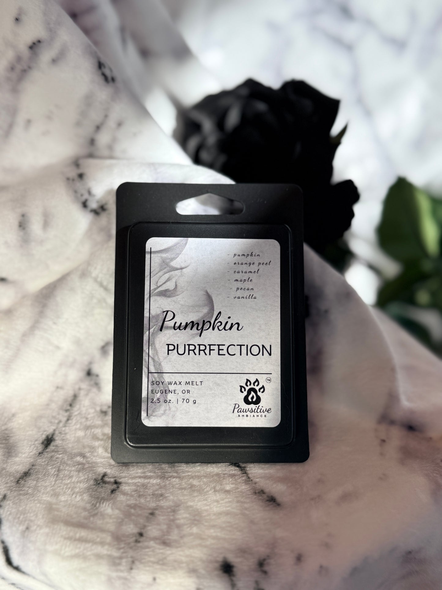 Soy wax melt labeled Pumpkin Purrfection featuring notes of pumpkin, orange peel, caramel, maple, pecan and vanilla.  Made in Eugene, Oregon. 2.5 oz. Manufactured by Pawsitive Ambiance.