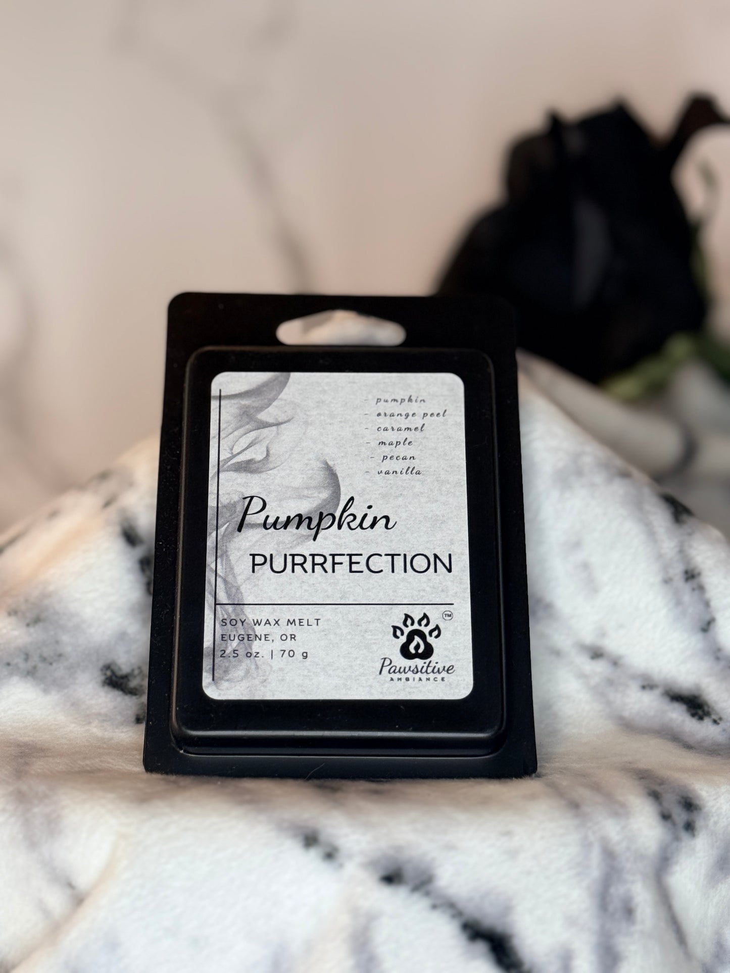 Hand poured soy wax melt labeled Pumpkin Purrfection featuring notes of pumpkin, orange peel, caramel, maple, pecan and vanilla.  Made in Eugene, Oregon. 2.5 oz. Manufactured by Pawsitive Ambiance.