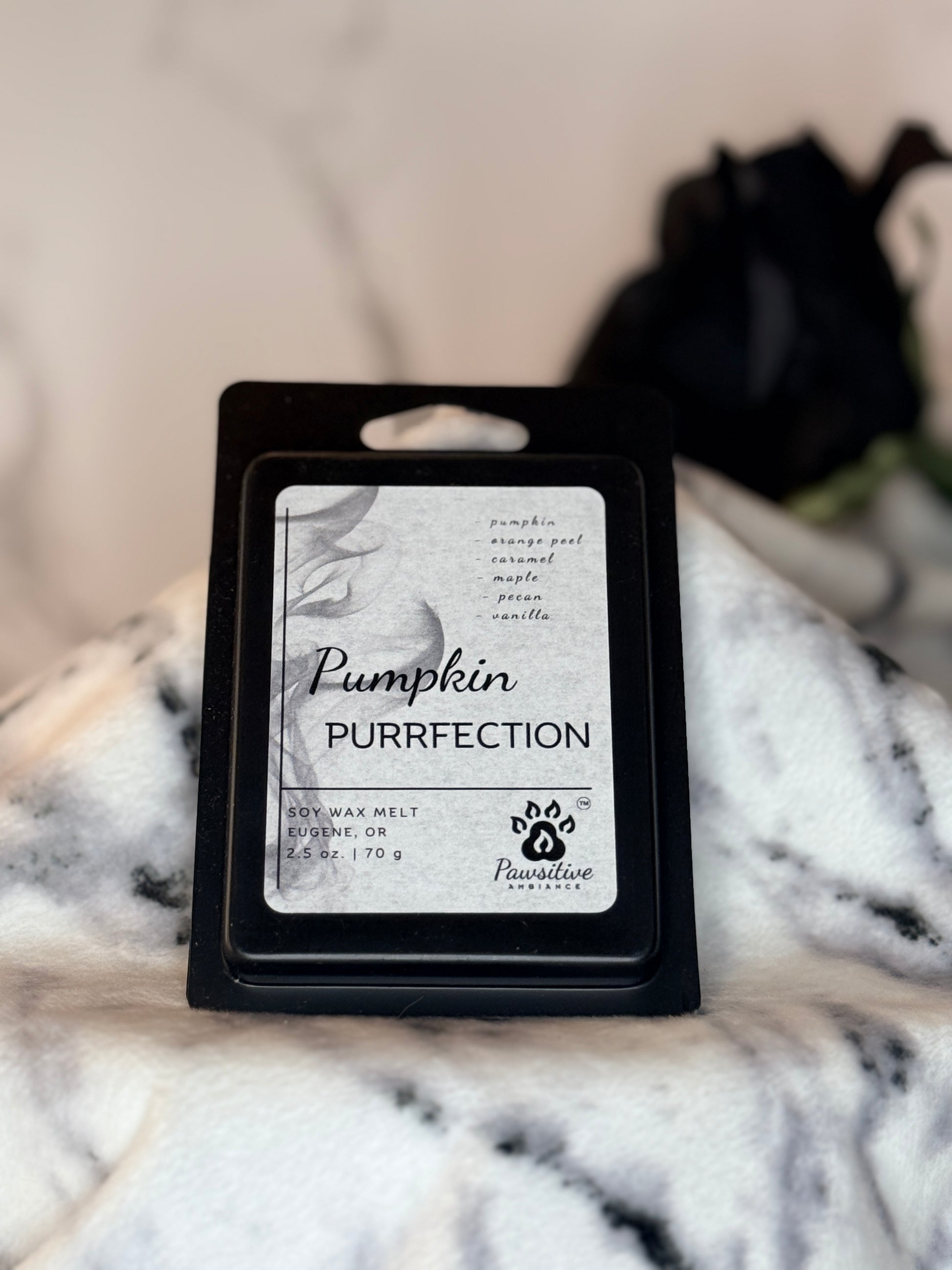 Hand poured soy wax melt labeled Pumpkin Purrfection featuring notes of pumpkin, orange peel, caramel, maple, pecan and vanilla.  Made in Eugene, Oregon. 2.5 oz. Manufactured by Pawsitive Ambiance.