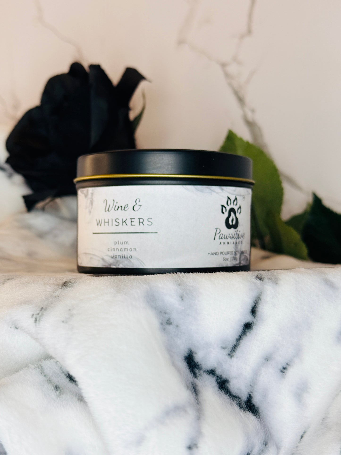 Hand-poured soy candle labeled Wine & Whiskers featuring notes of plum, cinnamon and vanilla.  6 oz. Manufactured by Pawsitive Ambiance.