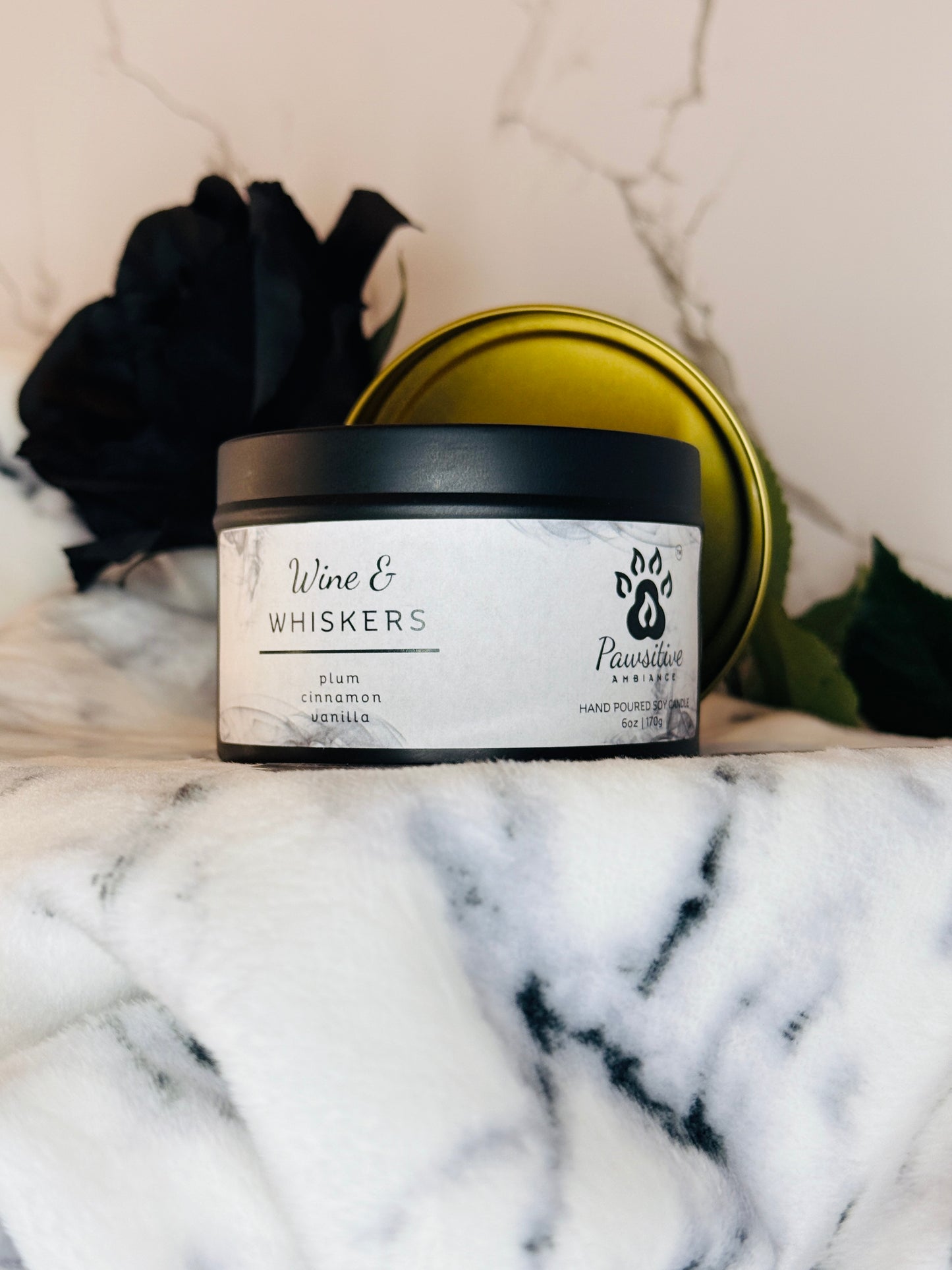 Hand-poured soy candle labeled Wine & Whiskers featuring notes of plum, cinnamon and vanilla.  6 oz. Manufactured by Pawsitive Ambiance.