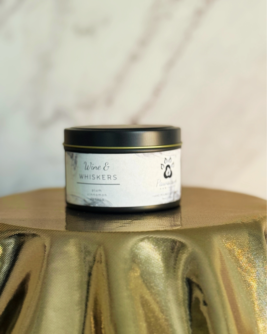 Hand-poured soy candle labeled Wine & Whiskers featuring notes of plum, cinnamon and vanilla.  6 oz. Manufactured by Pawsitive Ambiance.