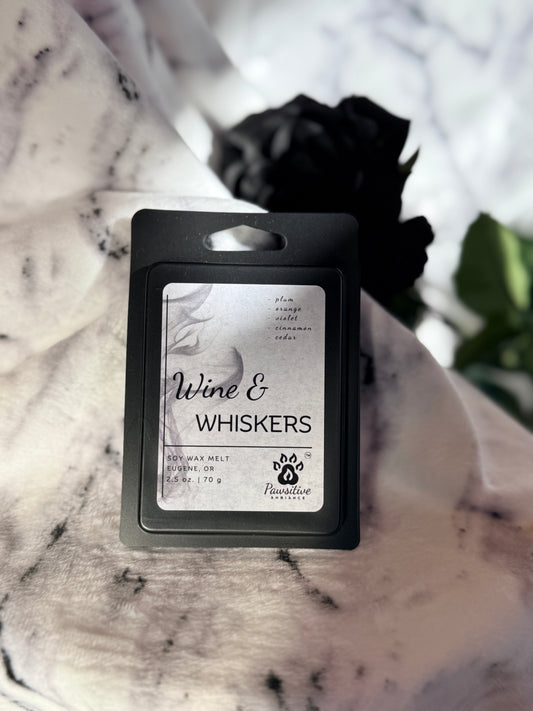 Soy wax melt labeled Wine & Whiskers featuring notes of plum, orange, violet, cinnamon, cedar.  Made in Eugene, Oregon. 2.5 oz. Manufactured by Pawsitive Ambiance.